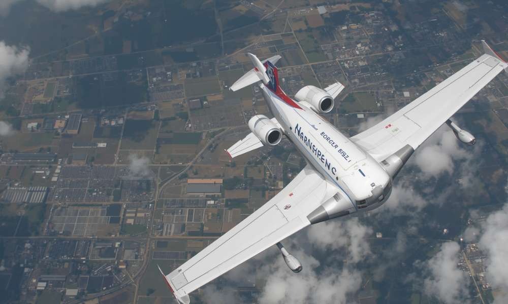 Private jet flying above clouds