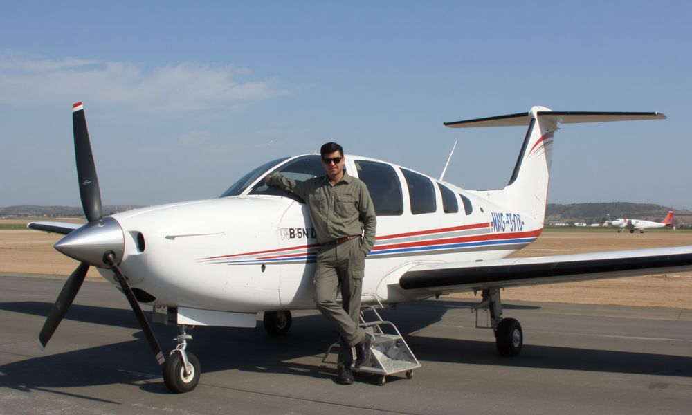Pilot trainee standing next to a training aircraft